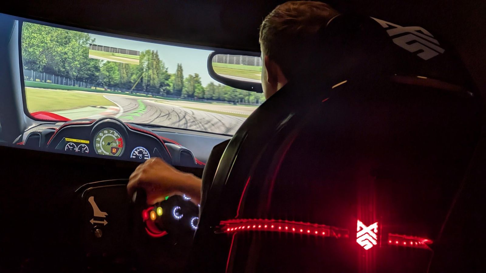Driver at the wheel of a racing simulator