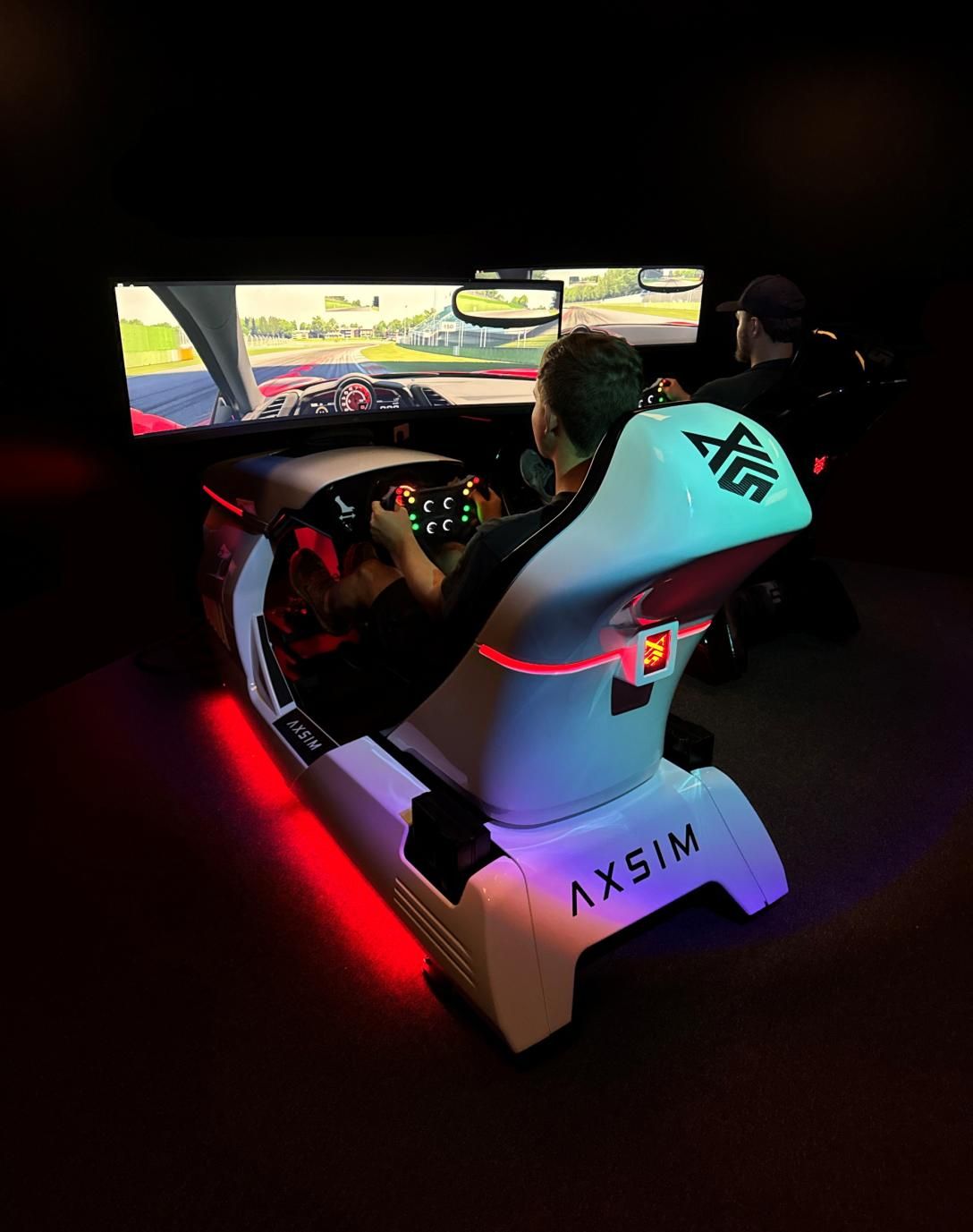 Racing simulator glowing in a dark room